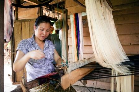 Khammouane Province, Laos, 2015 Handicrafts in action. Women are empowered through weaving and handicraft projects, raising money for their family and community. Photo taken during a Community Based Disaster Risk Reduction simulation. The exercises and drills focus on disaster preparedness and response at village level, ensuring communities are equipped with skills to activate emergency plans and save lives. Through the simulation project Lao Red Cross and partner French Red Cross, with support from the European Union, are improving safety for vulnerable communities.