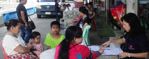 Thai Red Cross mobile dental clinic: Thai Red Cross nurse assesses vital signs of patients while they are waiting for their turn to see a dentist.