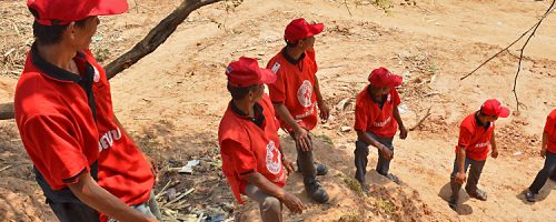 Khammouane Province, Laos, 2015 In line to fight fire. Village Disaster Protection Unit members form a water line to fight fire during a Community Based Disaster Risk Reduction simulation. The exercises and drills focus on disaster preparedness and response at village level, ensuring communities are equipped with skills to activate emergency plans and save lives. Through the simulation project Lao Red Cross and partner French Red Cross, with support from the European Union, are improving safety for vulnerable communities.