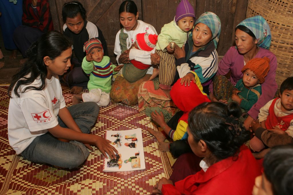 Pankala village The village is located about one hour and 15 minute walk from Sutywe village, which is on Keng Tung-Tachilek highway. There is no primary school in the village but children in the village can study up to grade 3 at a school whose teacher is appointed and paid by the village (Primary School is up to grade 5). Altogether 11 children learn at the school. Less than half of the children can go to school. There are 22 houses with 22 households. The total population is 106. Most villagers engage in farming. It is a Christian village and the majority of the villagers belong to Lahu ethnic group. The Keng Tung project renovated the water storage tank having 6 feet in diameter and 8 feet in height. It was day time when we arrived at village. During the health education session there were 14 people with only three men. That was the time when most people in the village were on their farms. Most of the participants were women, children and men who are not engaged in agriculture or who have got some other people to do the work. There were some old men and women looking after their grandchildren. Khine Khine Yu, project assistant, told us that she had to inform in two-three days in advance for those who are engaged in farming to be present at the health education session. One man volunteered to act as an interpreter for the session. Project staff Htoo Hlaing (Mr.) and Khine Khine Yu (Ms.) mainly talked about personal hygiene and environmental problem. They emphasised on the importance of washing ones hands before and after ones meals and after washing ones hands after one gets out from latrines. Water used from houses did not flow well and cow dung was seen here and there at the village. Khine Khine Yu tried to convince the villages to keep their environment clean. She explained, with the help of flipcharts, the benefits that a village can have by keeping it clean.