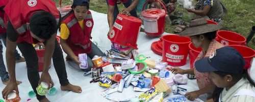 Myanmar 2015. Kalay. Aye Thar Yar village. Myanmar Red Cross local volunteers distributing hygien kits and shelter kits to flood affected people in Aye Thar Yar village. MRC local volunteers have been helping around the Kalay township area since the monsoon floods hit the area end of July.