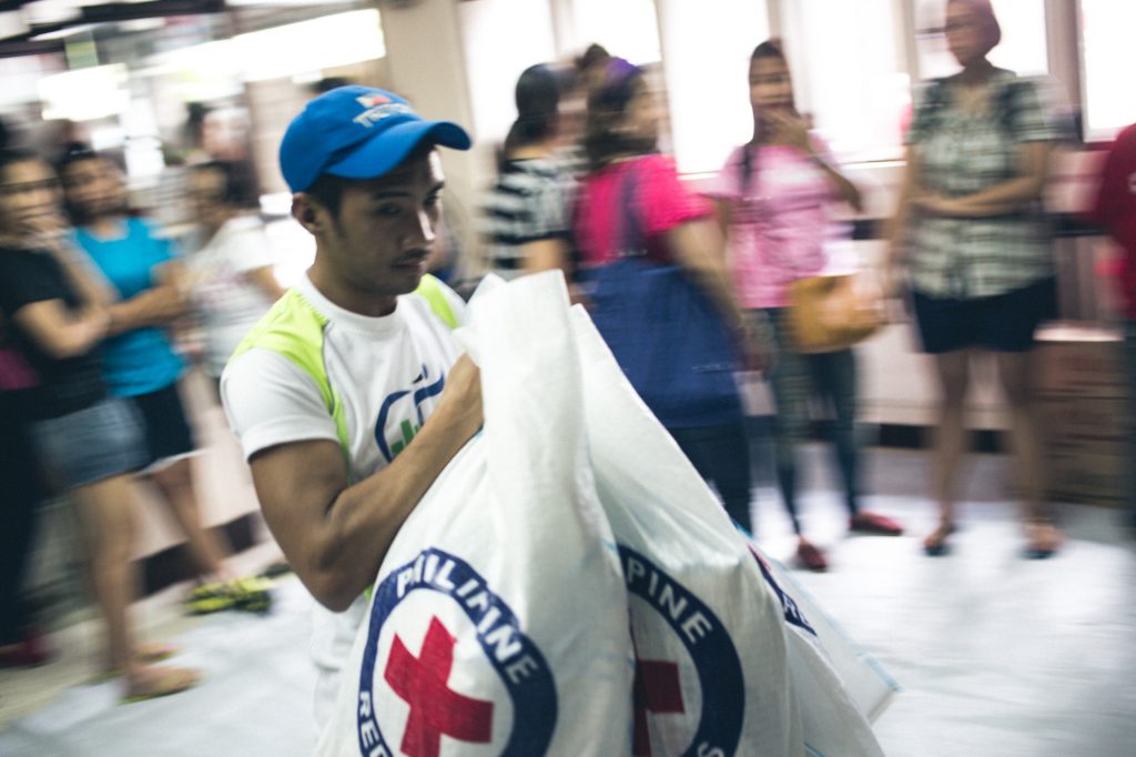 Philippines. Manila, 2013. Typhoon Haiyan struck Philippines 8th November, 2013. Volunteers and staff working with food items at Philippine Red Cross HQ. Jarkko Mikkonen/Finnish Red Cross.