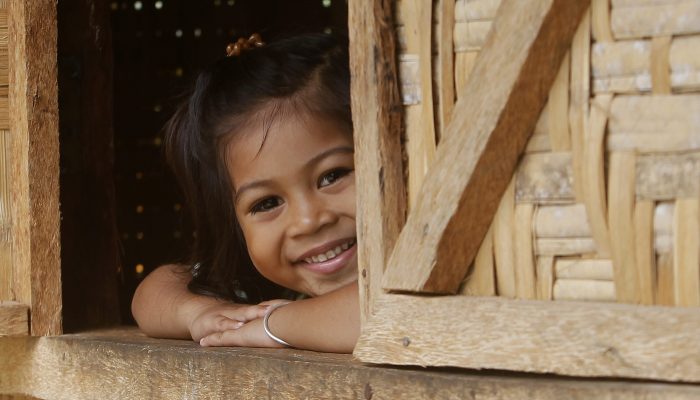 Alh Rose Pulinio, whose family is one of the beneficiary of full house, smiles as she looks out from the window of their home at Barangay Macopa in Monkayo, Compostela Valley southern Philippines November 30, 2013. One year after Typhoon Bopha locally known as Pablo destroyed houses and infrastructures and displaced thousands of residents, the IFRC and the Philippine Red Cross continue to help survivors recover with income generation projects and building of decent shelters. Photo by: Cheryl Gagalac